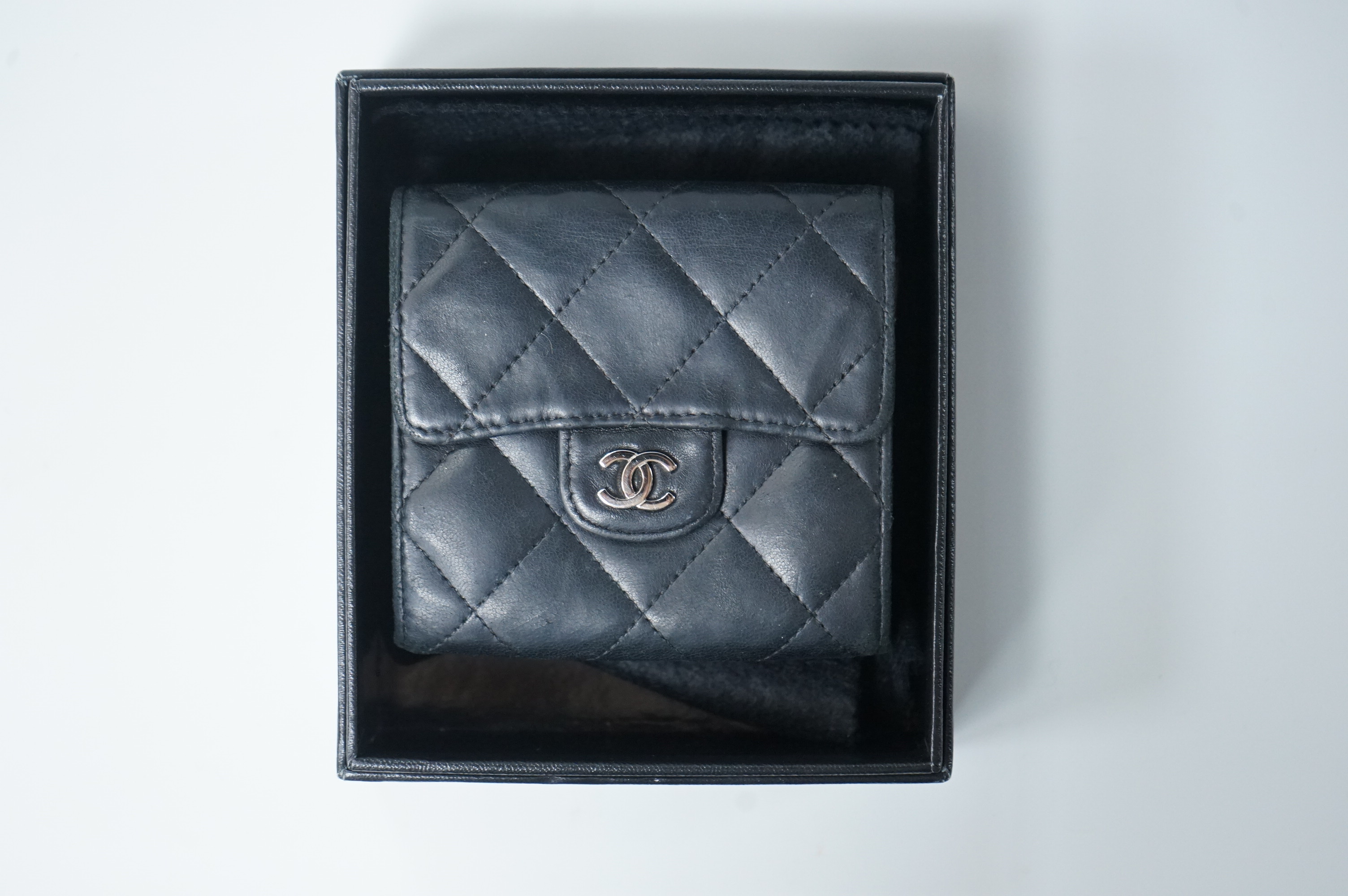 A Chanel classic double flap black leather purse, with original receipt, authenticity card numbered 10670211 and box, 10cm wide, Provenance: Purchased by the vendor in New York
